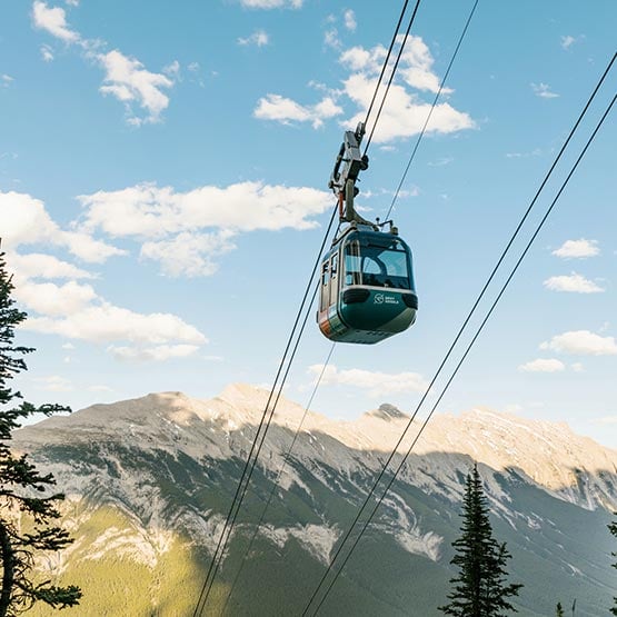 Banff Gondola travelling up tramway with mountain view in the background