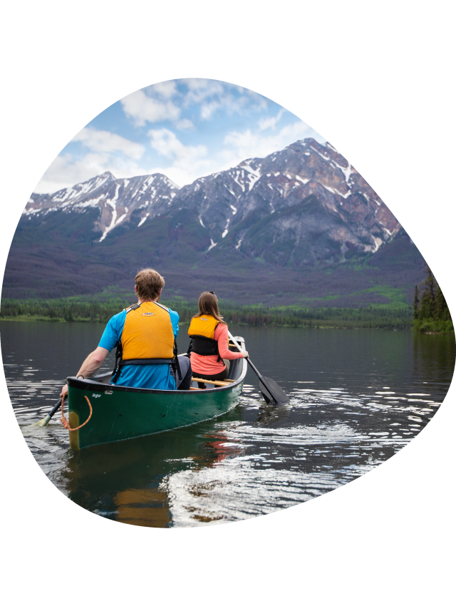 Two canoeists on a calm lake.